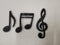 3 símbolos musicales de espuma con purpurina.